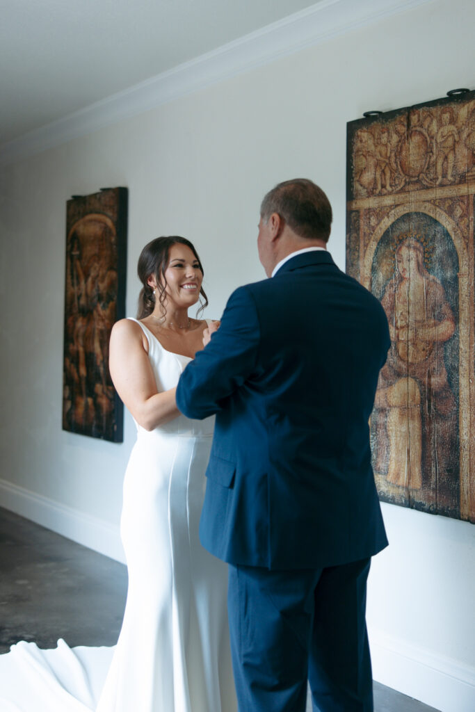 The bride and father seeing each other for the first time on the wedding day.