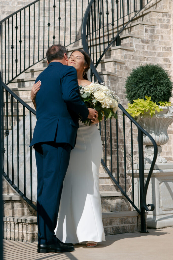Bride hugging her father before walking down the aisle. 