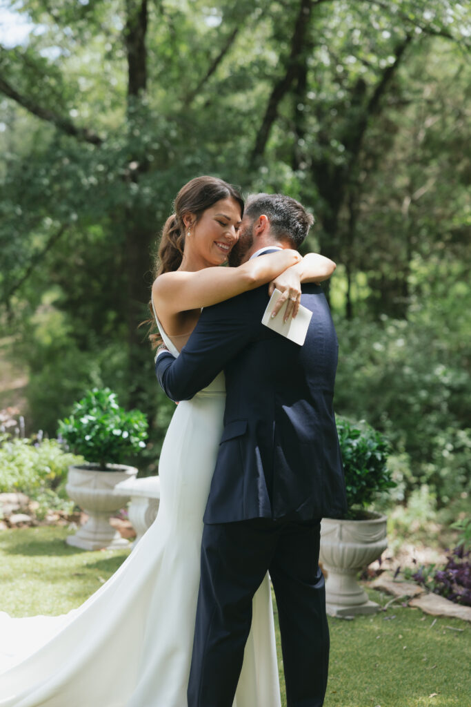 Wedding photography on film  of bride and groom hugging after reading vows during their first look.