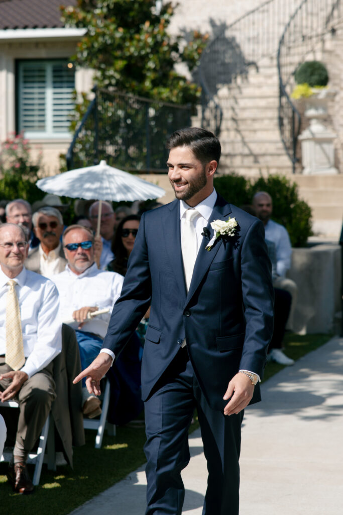 Groom walking down the aisle. 