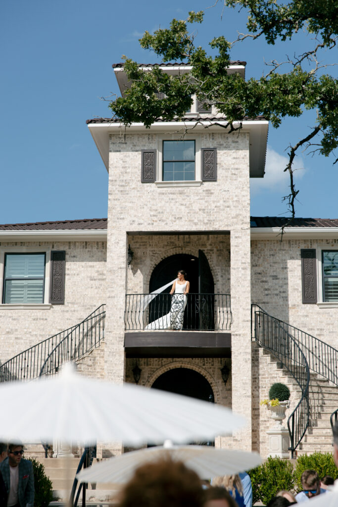 Bride looking off into the distance with her veil flowing in the wind.