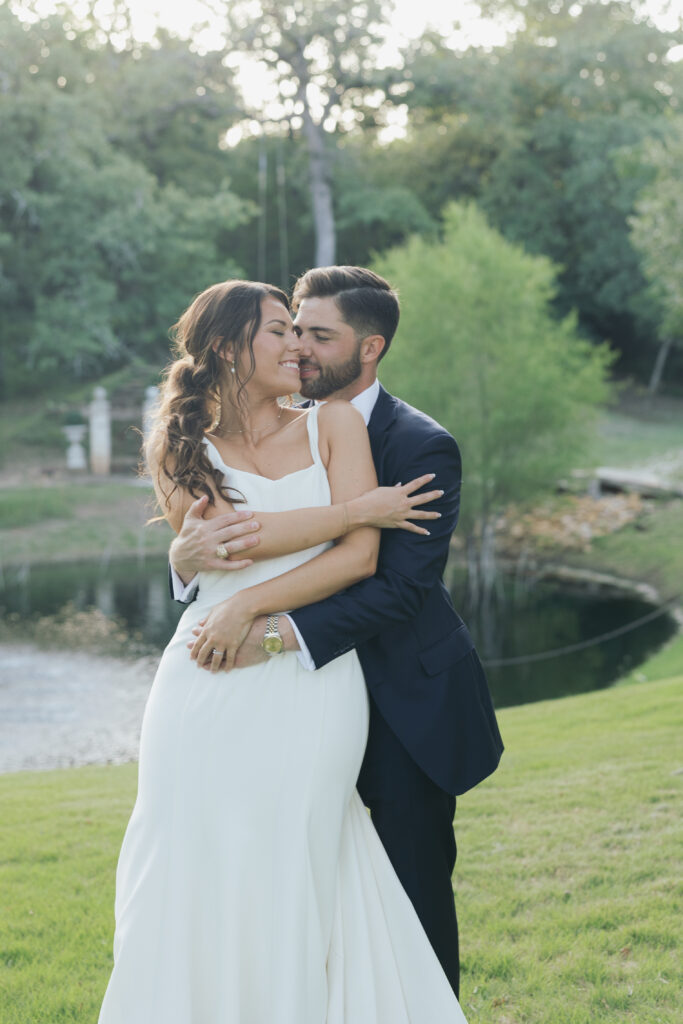 Bride and groom hugging one another.