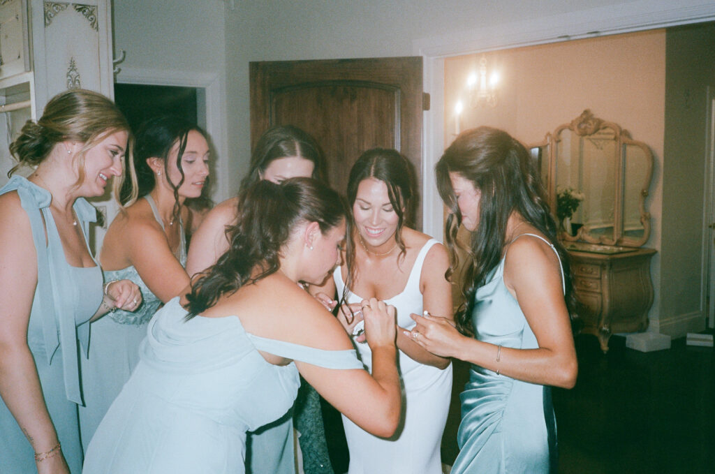 Wedding photography on film of the bridal party getting ready together.