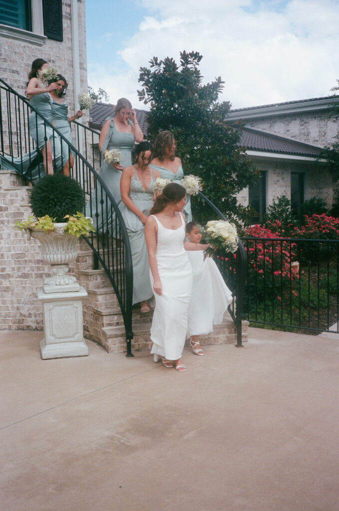 Wedding photography on film of a bridal party walking down stairs at La Bella Luna.