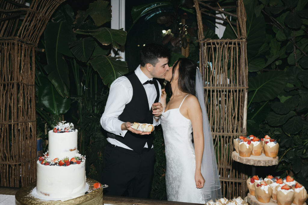 Couple eating wedding cake.