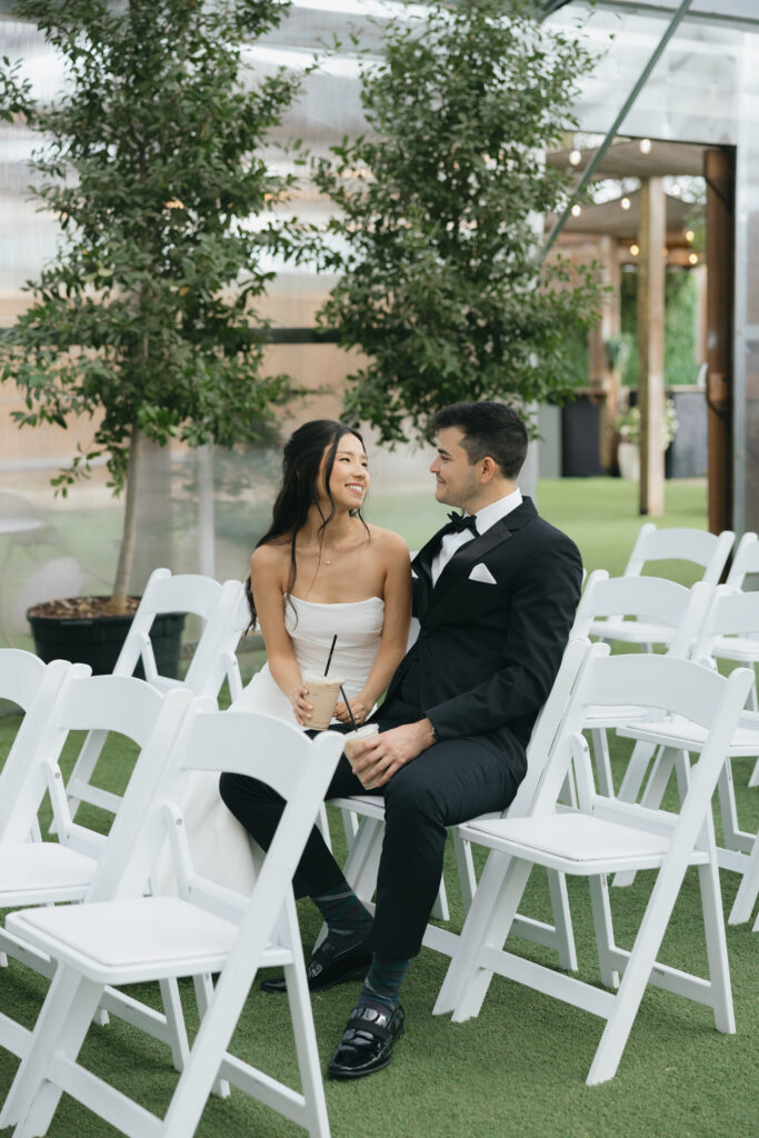 Bride and groom sitting wile drinking coffee as they relax before the ceremony, showcasing one of their intimate wedding ideas.