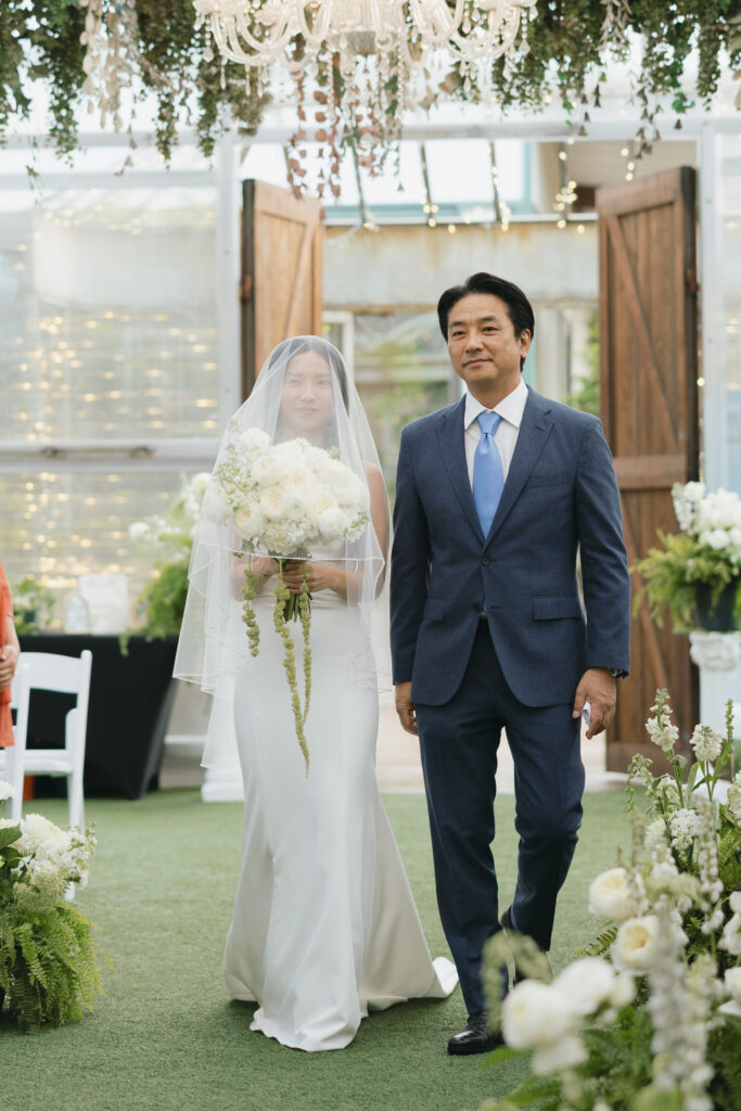 Bride and her father walking down the aisle at Honey Locust Farms Rockwall.