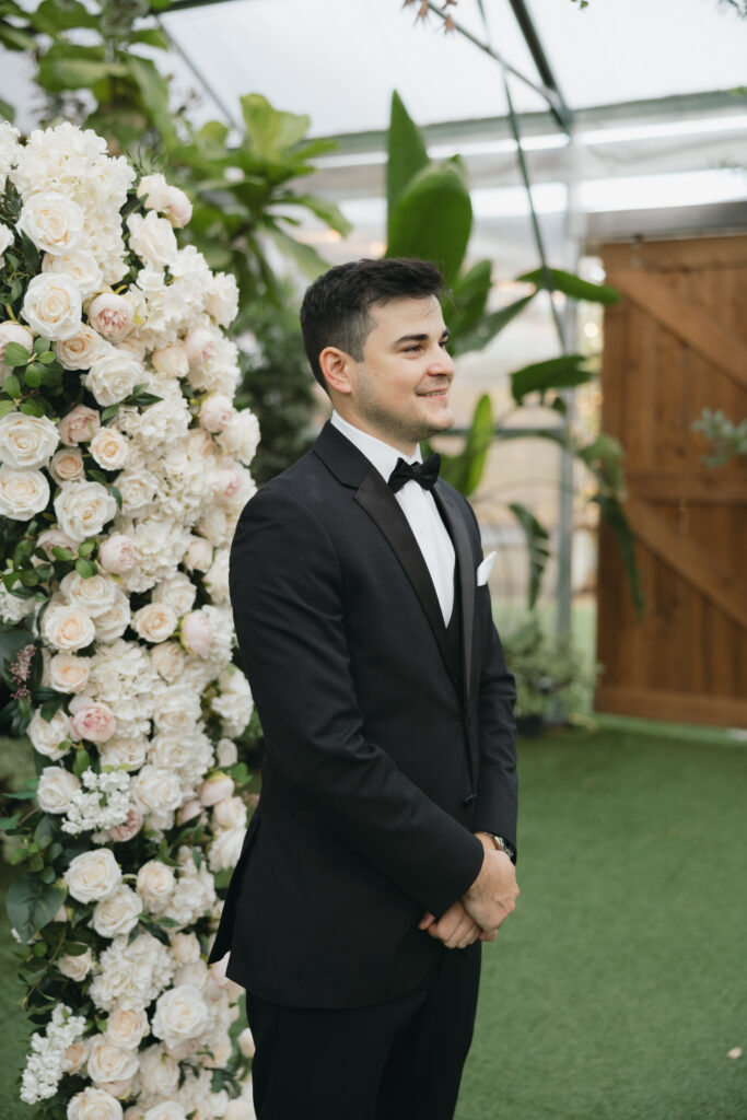 Groom watching the bride walk down the aisle.