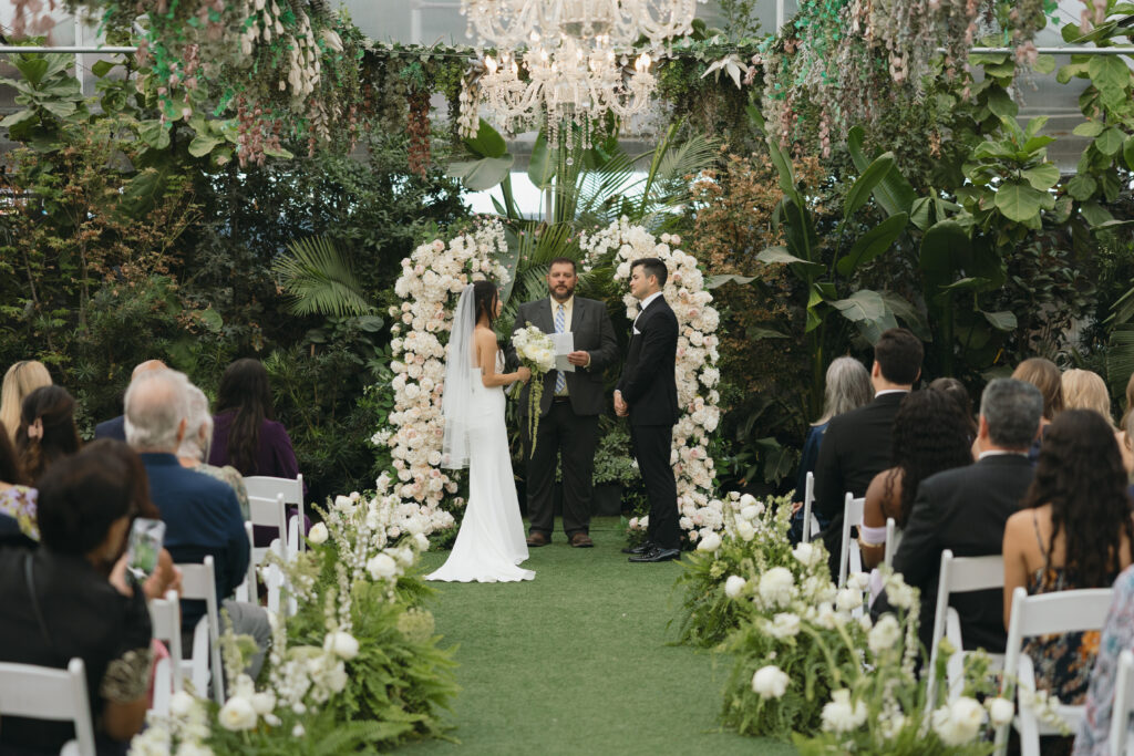 The wedding ceremony with the bride and groom and all their guests during the ceremony. 