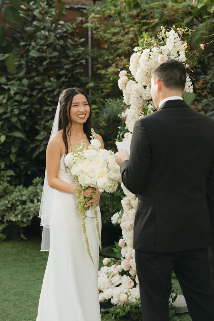 Bride smiling really big during the ceremony.