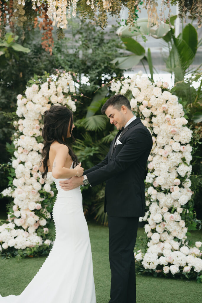 Groom seeing his bride for the first time during their first look, one of their intimate wedding ideas.