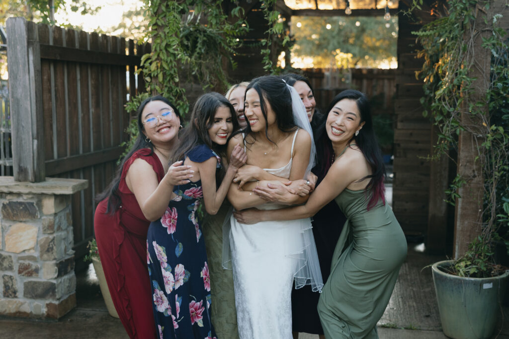 A big group hug with the bride.