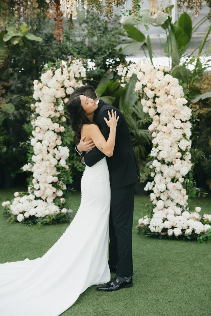 Hayden and Sunny embracing during their first look, a perfect example of intimate wedding ideas.
