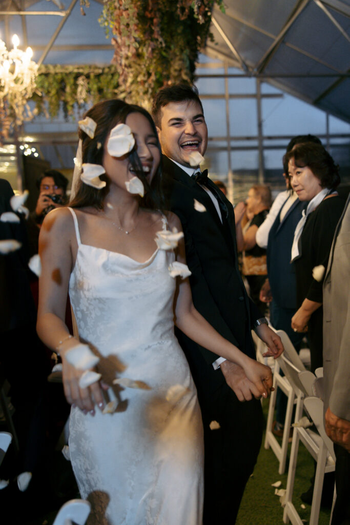 Couple walking through the wedding reception at Honey Locust Farms in Rockwall, Texas.