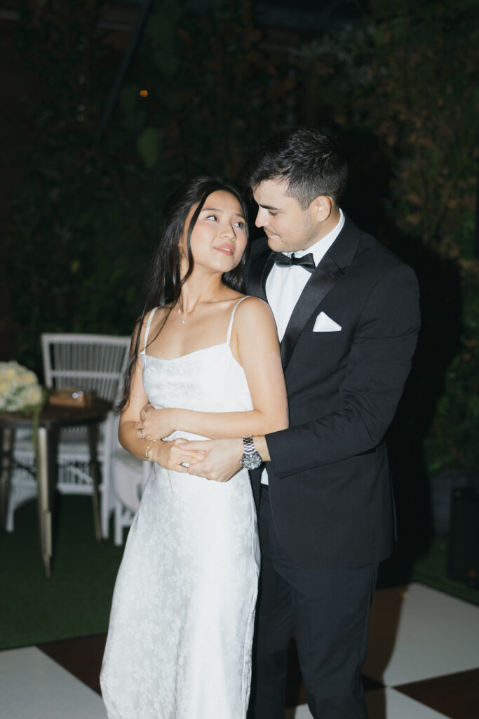 Bride and groom looking at one another romantically during their first dance.