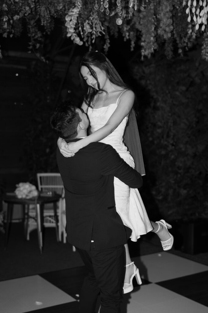 Groom picking up his bride during their first dance.