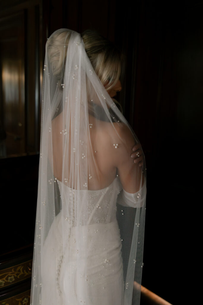 A bride showing off her veil from behind.