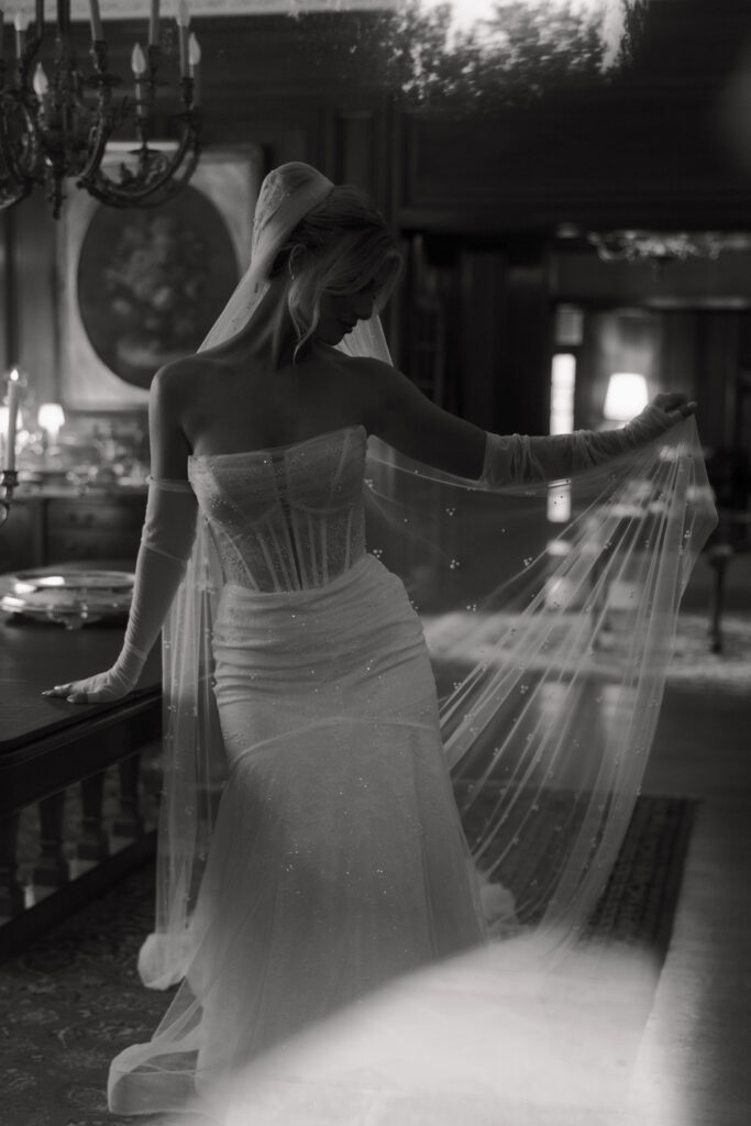 Bride moving her veil for bridal portraits at the Aldredge House.