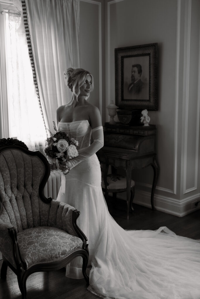 Bride looking to the side while holding flowers.