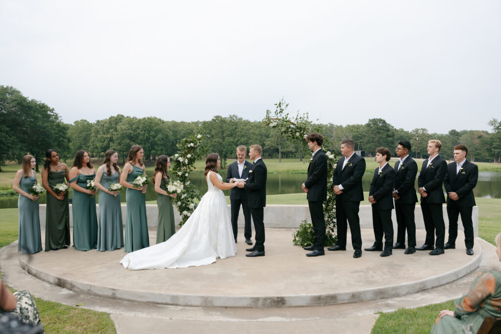 bride and groom holding hands during their wedding ceremony